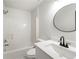 Contemporary bathroom features a tub/shower and white vanity with black faucet at 5789 Star Flower Dr, Ellenwood, GA 30294