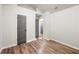 An open bedroom featuring wood-style floors, neutral walls, and a closet at 5789 Star Flower Dr, Ellenwood, GA 30294