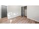 A bright bedroom featuring wood-style floors and a closet at 5789 Star Flower Dr, Ellenwood, GA 30294