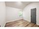 Cozy bedroom with vaulted ceiling, wood-look floors, and a window at 5789 Star Flower Dr, Ellenwood, GA 30294