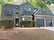Beautiful two-story brick home featuring a well-manicured front yard and black front door at 5789 Star Flower Dr, Ellenwood, GA 30294