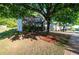Landscaped front yard with mature trees surrounding a well maintained brick home at 5789 Star Flower Dr, Ellenwood, GA 30294
