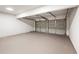 Spacious two-car garage with neutral-toned walls and floors at 5789 Star Flower Dr, Ellenwood, GA 30294