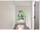 Well-lit hallway with hardwood floors featuring view of decorative window at 5789 Star Flower Dr, Ellenwood, GA 30294