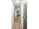 Long hallway with wood-look flooring and neutral gray doors and hardware at 5789 Star Flower Dr, Ellenwood, GA 30294