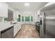 Modern kitchen featuring stainless steel appliances, white cabinets, and an eat-in nook at 5789 Star Flower Dr, Ellenwood, GA 30294