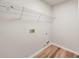 Small laundry room features hardwood floors, washer hookups and metal shelving at 5789 Star Flower Dr, Ellenwood, GA 30294