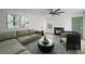Cozy living room with a ceiling fan, fireplace, and neutral-toned furniture at 5789 Star Flower Dr, Ellenwood, GA 30294