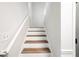 Bright staircase with wooden steps and white risers and railings at 5789 Star Flower Dr, Ellenwood, GA 30294
