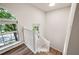 Bright staircase featuring a decorative window with view of mature trees at 5789 Star Flower Dr, Ellenwood, GA 30294