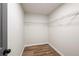 White walk-in closet features hardwood floors and metal shelving at 5789 Star Flower Dr, Ellenwood, GA 30294