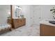 Well-lit bathroom with marble floors, a double vanity with white countertop, and modern fixtures at 114 Briargate Dr, Johns Creek, GA 30097