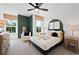 This bedroom has a ceiling fan, bedside table, white walls and stylish decorations at 114 Briargate Dr, Johns Creek, GA 30097