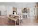 Dining area with modern table, bench seating, and open layout to the kitchen at 114 Briargate Dr, Johns Creek, GA 30097