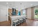Bright kitchen with a quartz island, pendant lighting, stainless appliances, and hardwood flooring at 114 Briargate Dr, Johns Creek, GA 30097