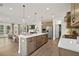 Open-concept kitchen and living area with center island, stainless steel appliances and plenty of natural light at 114 Briargate Dr, Johns Creek, GA 30097
