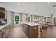 Bright kitchen open to dining area featuring a center island and stainless steel appliances at 114 Briargate Dr, Johns Creek, GA 30097