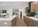 Modern kitchen design showcasing center island, stainless steel appliances, and beautiful backsplash at 114 Briargate Dr, Johns Creek, GA 30097