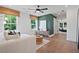 Spacious living room with large windows, hardwood floors, and modern furnishings at 114 Briargate Dr, Johns Creek, GA 30097