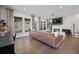 Spacious living room with large windows, hardwood floors, and a cozy fireplace at 114 Briargate Dr, Johns Creek, GA 30097
