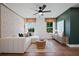 Comfortable living room with lots of natural light, stylish decor, and modern ceiling fan at 114 Briargate Dr, Johns Creek, GA 30097