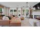 Bright living room featuring hardwood floors, a fireplace, and a stylish leather sectional at 114 Briargate Dr, Johns Creek, GA 30097
