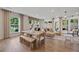 Living and dining area features large windows, modern decor, and hardwood floors at 114 Briargate Dr, Johns Creek, GA 30097