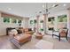 Comfortable living room with large windows, a stylish leather sofa, and modern decor at 114 Briargate Dr, Johns Creek, GA 30097