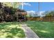 Lush backyard featuring a swing under a wooden pergola at 2210 Leafmore Dr, Decatur, GA 30033