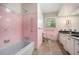 Retro bathroom featuring pink tile, updated fixtures, and a vanity with granite countertop at 2210 Leafmore Dr, Decatur, GA 30033