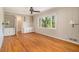 Bright bedroom with hardwood floors, built-in shelving, a ceiling fan, and large windows offering a serene view at 2210 Leafmore Dr, Decatur, GA 30033