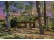 Two-story brick home nestled among mature trees, boasting a balcony and ample windows for a bright, airy feel at 2210 Leafmore Dr, Decatur, GA 30033