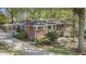 Lovely brick home featuring a carport, mature trees and meticulously maintained lawn, creating a welcoming curb appeal at 2210 Leafmore Dr, Decatur, GA 30033