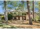 Two-story brick home nestled among mature trees, boasting a balcony and ample windows for a bright, airy feel at 2210 Leafmore Dr, Decatur, GA 30033
