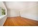 Spacious living room offers hardwood floors, large window and neutral paint at 2210 Leafmore Dr, Decatur, GA 30033