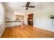 Open-concept living room with hardwood floors, neutral walls, built-in cabinetry, and seamless flow into the adjacent kitchen at 2210 Leafmore Dr, Decatur, GA 30033