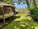 A backyard with a deck, mature trees, and a lush green lawn at 1150 Orchard Way, Roswell, GA 30075