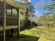This backyard offers a screened porch, mature trees, and a view of the chimney at 1150 Orchard Way, Roswell, GA 30075