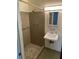 Bathroom features a tiled shower with a sink, a mirror, and a light fixture at 1150 Orchard Way, Roswell, GA 30075
