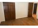 Bedroom with wood floors, closet, and a door leading to another room at 1150 Orchard Way, Roswell, GA 30075