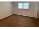 This bedroom features wood floors and a window with wood blinds, offering a bright and airy atmosphere at 1150 Orchard Way, Roswell, GA 30075