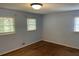 Comfortable bedroom with hardwood floors and multiple windows for plenty of light at 1150 Orchard Way, Roswell, GA 30075