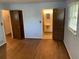 Bedroom with hardwood floors, access to bathroom and hallway, and a window that provides natural light at 1150 Orchard Way, Roswell, GA 30075