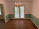Dining area with hardwood floors, soft blue accents, and French doors leading to the backyard at 1150 Orchard Way, Roswell, GA 30075