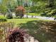 Lush front yard with mature trees and well-maintained lawn offers great curb appeal at 1150 Orchard Way, Roswell, GA 30075
