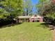 Charming single-Gathering home featuring a well-manicured lawn and mature trees at 1150 Orchard Way, Roswell, GA 30075