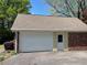 Spacious two-car garage with white door and brick accents at 1150 Orchard Way, Roswell, GA 30075