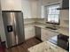 Modern kitchen featuring stainless steel appliances, granite countertops, and white cabinets at 1150 Orchard Way, Roswell, GA 30075