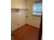 Functional laundry area with shelving and convenient hookups for washer and dryer at 1150 Orchard Way, Roswell, GA 30075