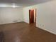 Living room showing wood floors and a door leading to another room at 1150 Orchard Way, Roswell, GA 30075